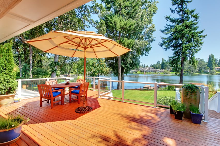 Wood Deck Design Ideas modern mangaris wood deck silverlake los feliz area of los angeles 50 Wood Deck Design Ideas Wood Deck With Beautiful Lake View And Outdoor Patio Furniture With Umbrella Wood Deck Design Ideas elevated covered sundeck with stairs leading down into the yard 50 Wood Deck Design Ideas Wood Deck With Beautiful Lake View And Outdoor Patio Furniture With Umbrella